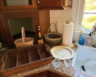 Woven rattan divided tray, splint baskets, a wooden paper towel holder, a transferware plate and glass candle holders