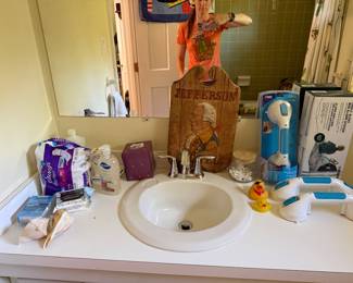 Bathroom vanity with the Jefferson sign, boxed safety grab bars and bath supplies