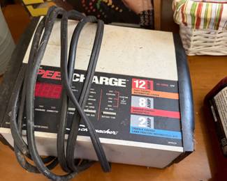 Schumacher SpeedCharge battery charger with a vintage Lite-Brite box behind