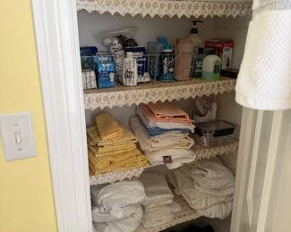 Linen closet of towels, sheets and household toiletries