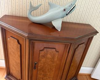 Octagonal burl wood console cabinet with a shark sculpture on top