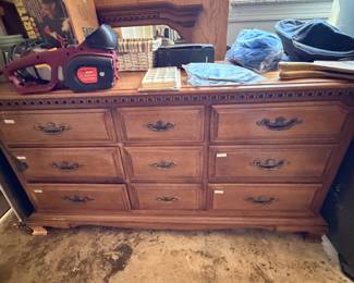 Nine drawer wood dresser holding the electric chainsaw and workshop items