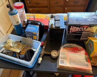 Herculiner truck bed liner kits, a propane torch tank, water filter cartridge, door edge trim and plumbing fittings