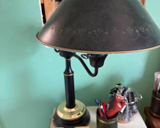 Black and gold tole desk lamp with stenciled metal shade, tape dispensers and desk supplies