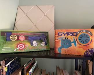 Marshmallow Shooter and Gyrosphere toys in boxes with a fabric memo board
