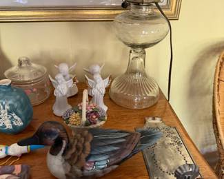 Glass oil lamp, porcelain angel figurines, carved painted duck decoys and a punched tin sconce
