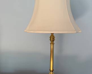 Tall brass column table lamp with bell shade and a Whitman's Sampler tin