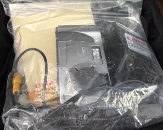 Bagged Casio device with cables and accessories in a padded camera bag