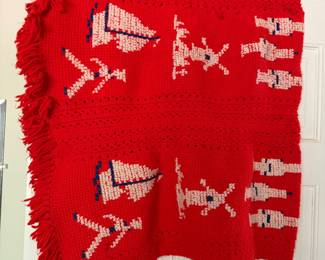 Handmade red crocheted Christmas afghan with tree, reindeer and Santa motifs