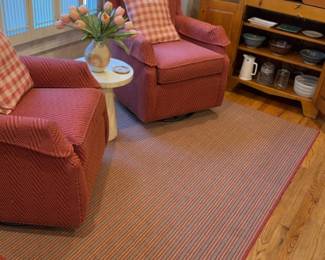 57”L x 86”W | Rug in brown and Red with a Striped Pattern and Red Border.