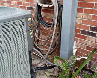 Lot 805: Garden Hoses, Hose Storage, Ladder, and Outdoor Decor