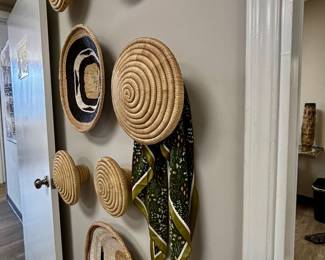 Gallery wall of handwoven baskets and woven decorative wall hangings