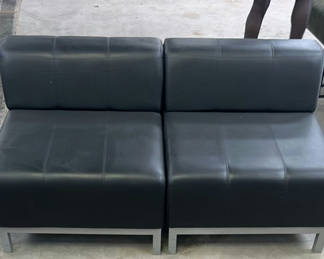 Lot 208: Two Black Armless Lounge Chairs