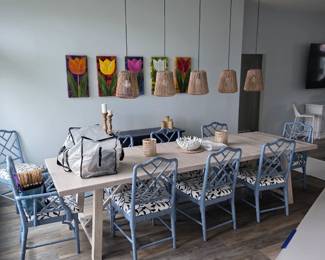 Whitewashed trestle dining table with blue Chippendale-style chairs