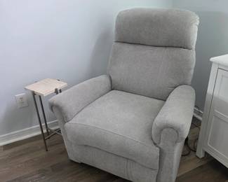 Gray upholstered recliner with marble-look C-shaped side table