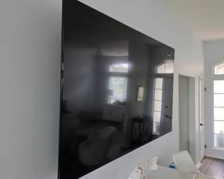 Large wall-mounted flat-screen television with slim black bezel