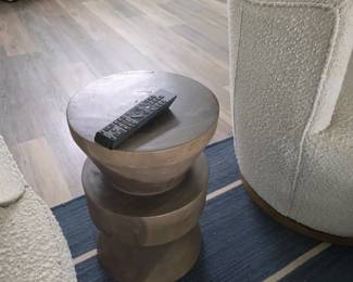 Turned wood hourglass side table in weathered finish with boucle chairs