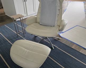 Cream leather-look swivel lounge chair and ottoman on chrome base