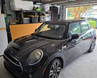 MINI Cooper hatchback in dark gray with black roof and white hood stripes