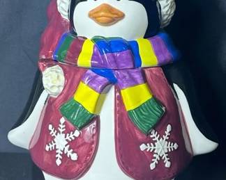 Colorful Christmas Penguin Cookie Jar Cheerful ceramic penguin cookie jar dressed for Christmas in a burgundy Santa hat and coat with snowflake accents and a bright striped scarf. A fun, colorful piece for a holiday kitchen or cookie jar collection.  Removable head/lid Holly and snowflake details See photos for condition and measurements Market Insight & Estimated Market Value: Festive penguin décor has plenty of Christmas display appeal, and the bright colors make this an especially fun seasonal piece.  Estimated Market Value: $25–$40