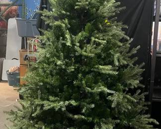 7.5 Ft Pre-Lit Artificial Christmas Tree With Stand Full 7.5 ft artificial Christmas tree with a dense, traditional evergreen look and included metal stand. Pre-strung with lights for easy holiday decorating.  Approx. 7.5 ft tall Includes metal stand Stands securely without wobbling Lighting could not be tested; sold as-is See photos for condition and details   Market Insight & Estimated Market Value: A full-size tree with plenty of branches for ornaments and a classic shape that makes a great centerpiece for holiday decorating.    Estimated Market Value: $75–$125