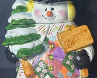 Snowman With Christmas Tree Ceramic Cookie Jar Cheerful ceramic snowman cookie jar featuring a colorful patchwork coat, top hat, scarf, Christmas tree and raised “BRRRR” sign. The sculpted details and bright colors make it a fun piece for holiday kitchen décor.  Removable snowman head/lid Paint chipping, fading and surface wear present See photos for condition and measurements Market Insight & Estimated Market Value: A whimsical Christmas cookie jar with lots of dimensional detail and festive display appeal.  Estimated Market Value: $25–$40
