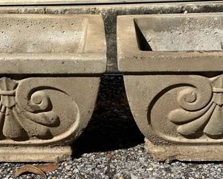 Pair of Decorative Square Concrete Planters Matching pair of substantial square concrete planters with raised scrollwork detailing. Great for a porch, patio, entryway, or garden.  Approx. 13.5" x 13.5" x 9.5"H each Drainage holes Chips along bases; see photos for condition   Market Insight & Estimated Market Value: Their matching design and substantial construction make these especially nice for flanking an entryway or creating a symmetrical garden display.    Estimated Market Value: $45–$75 for the pair
