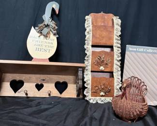 Vintage Country Kitchen Decor With Wooden Shelves & Turkey Basket Charming assortment of country-style kitchen and wall décor with warm wood tones, heart cutouts and folk-art details. Includes a wooden heart shelf, lace-trimmed wall organizer, goose wall hanging and woven turkey basket in an Avon Gift Collection box.  Heart shelf approx. 20" x 7" Wall organizer approx. 21"L Includes two wooden wall pieces plus decorative goose and turkey basket See photos for condition and details   Market Insight & Estimated Market Value: A fun grouping for farmhouse, country or cottage décor, with several pieces ready for display or repurposing.    Estimated Market Value: $35–$60
