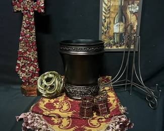 Burgundy & Gold Home Decor Collection Coordinating home decor in rich burgundy, gold and bronze tones, with plenty of texture for a dining room, entryway or living space.  Table runner approx. 71"L x 17.5"W Jeweled cross on wooden pedestal approx. 22.5"H 4 beaded napkin rings Decorative planter 2 metal plate/picture stands Wine-themed wall decor Openwork decorative sphere Please see photos for condition and items included Market Insight & Estimated Market Value: A nicely coordinated collection that makes it easy to create a warm, elegant tablescape or room display.  Estimated Market Value: $45–$75
