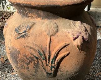 Large Terracotta Garden Pot With Butterfly & Floral Relief Large terracotta planter with raised butterfly, flower, and foliage designs and a naturally weathered finish. At 22" tall, it has great scale for a porch, patio, or garden.  Approx. 19"W x 22"H Drainage hole Weathered finish with remnants of color Crack along rim/upper body as pictured See photos for condition and details   Market Insight & Estimated Market Value: The large size, aged terracotta look, and dimensional garden motif give this plenty of decorative appeal even beyond use as a planter.    Estimated Market Value: $50–$90