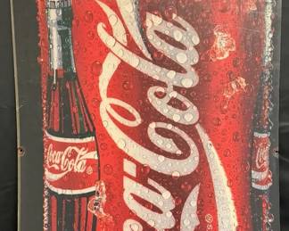 Vintage Coca-Cola Bottle & Can Plexiglass Advertising Display Bold Coca-Cola advertising display featuring an ice-cold bottle and can graphic with water droplets and ice. The large format and classic Coke imagery make this a great piece for a game room, garage, diner or advertising collection.  Plexiglass/acrylic display panel Pre-drilled mounting holes Surface scratches throughout; many are more noticeable when viewed at an angle Additional wear from prior display/use See photos for condition   Market Insight & Estimated Market Value: Classic Coca-Cola advertising remains popular for retro kitchens, game rooms, garages and soda memorabilia collections.    Estimated Market Value: $60–$100