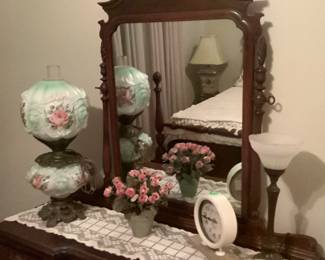 Antique hurricane lamp with roses.