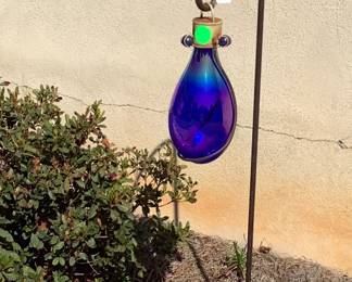 Shepherd’s hook with cobalt blue glass bottle