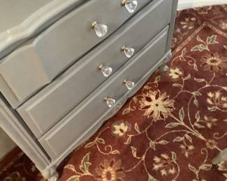 The bottom of the cabinet with glass knows in breakfast room.