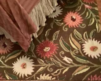 The beautiful rug with the rust and cream colors
