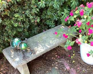 Cement bench with metal big ant.