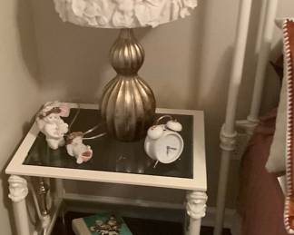 One of the cast iron end tables with glass top.  Sitting on top is one of two beautiful lamps.