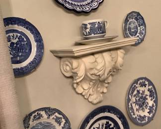 Blue plates, white shelf with blue cup and saucer.