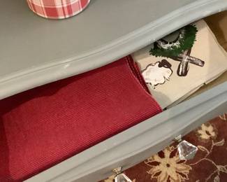 Place mats, table cloths,in cabinet.