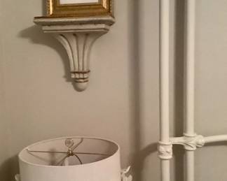 2 wall sconces with pictures of flowers on top.