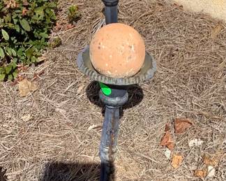 Metal stand with round ball.