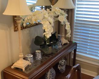Beautiful antique gold mirror hanging behind sofa table.
