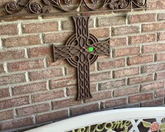 Metal hanger with metal cross below.