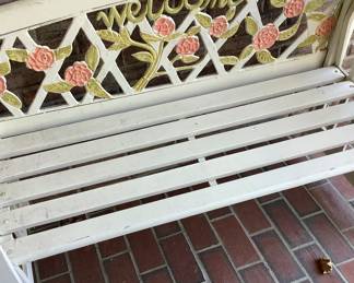 White bench on Freon with roses and welcome.