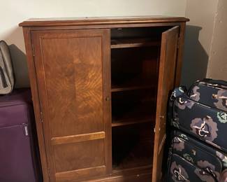 Beautiful wooden cabinet- luggage all around it