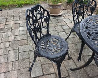Ornate cast aluminum patio chair with floral back