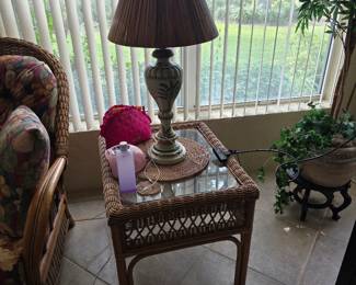 Wicker and rattan side table with glass top and table lamp
