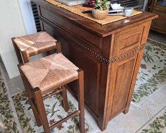 Wood bar counter with two rush-seat bar stools