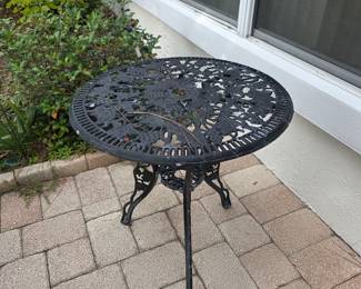 Round cast aluminum patio table with openwork top