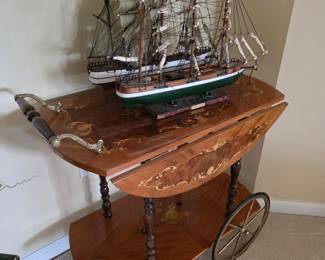 Wood tea cart with leaves extended and model sailing ship